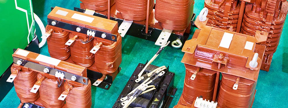 Group of orange high-voltage transformers.