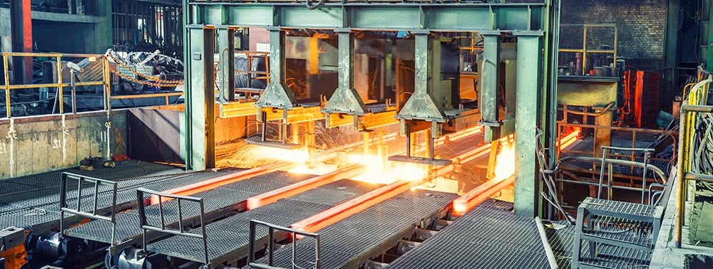 Sparks fly during industrial metal processing.